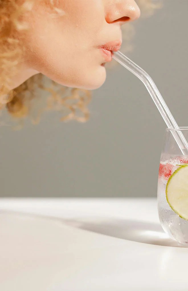 Photo of a model drinking a cocktail beverage.