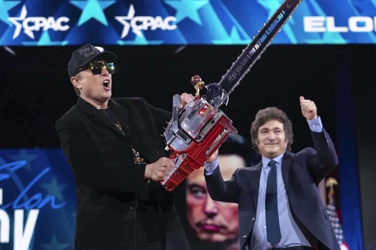 Elon Musk holds up a chainsaw onstage during the Conservative Political Action Conference (CPAC) in National Harbor, Maryland, U.S., February 20, 2025.