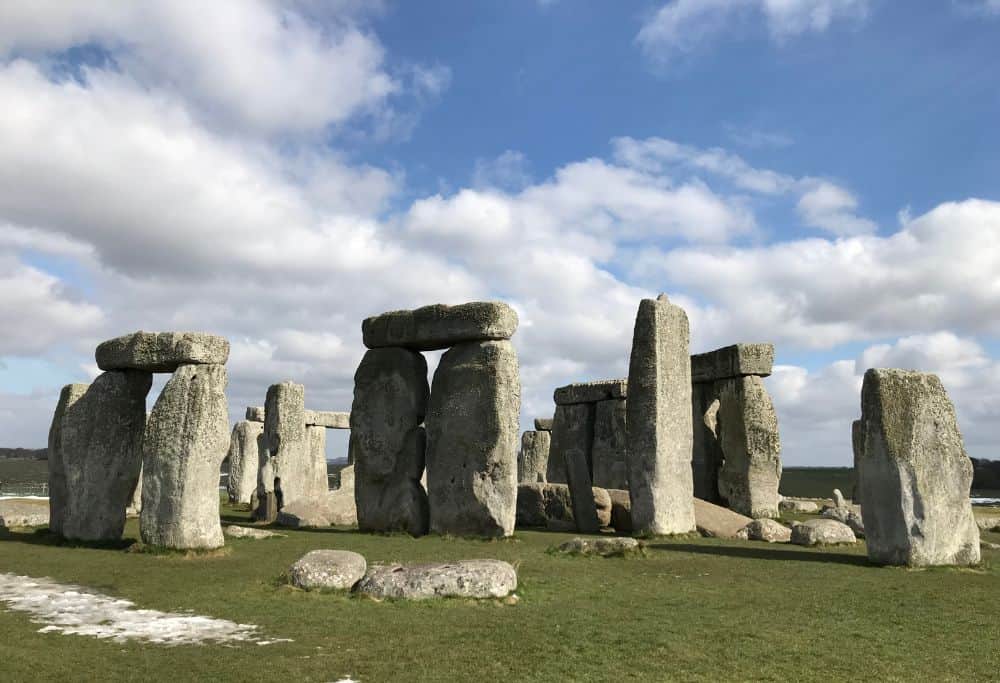 Close-up of Stonehenge with blue sky and clouds.