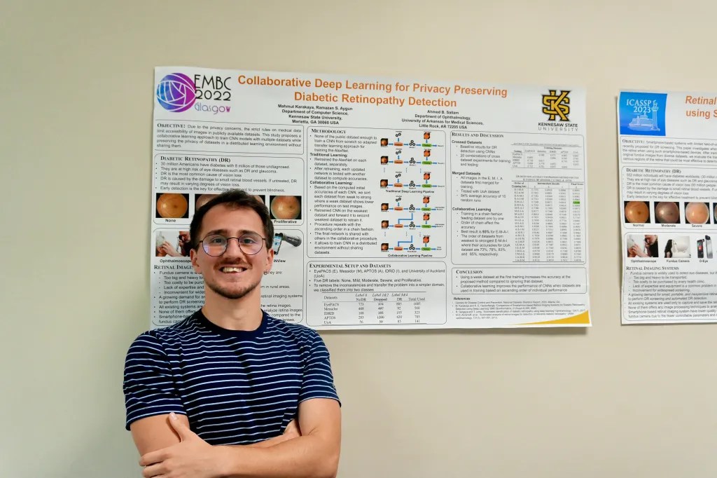 AI master’s student Akifcan Özbulut stands in front of a poster displaying his team’s current research at KSU. Photo by Devyn Byers.
