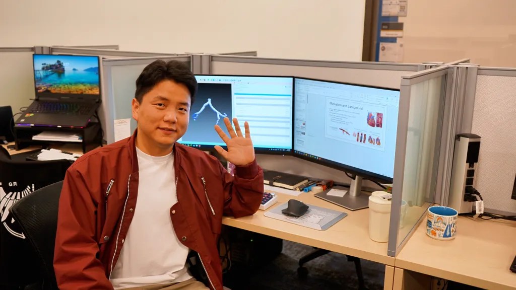 Ph.D. candidate Huan Huang sits in his team’s lab on the Marietta campus. The monitors behind him display parts of his research with coronary artery disease. Photo by Devyn Byers.