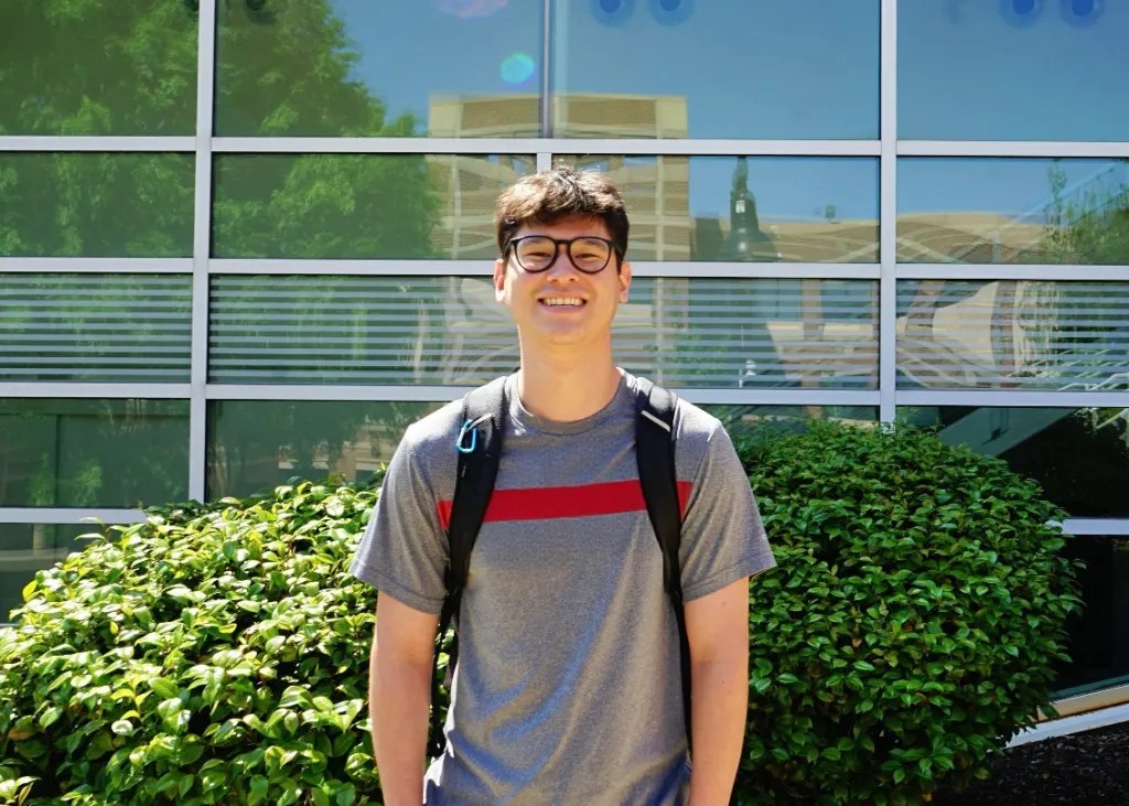 KSU student Joseph Stanziano stands outside of the Academic Building on the Marietta campus. Photo by Devyn Byers, edited with AI assistance.