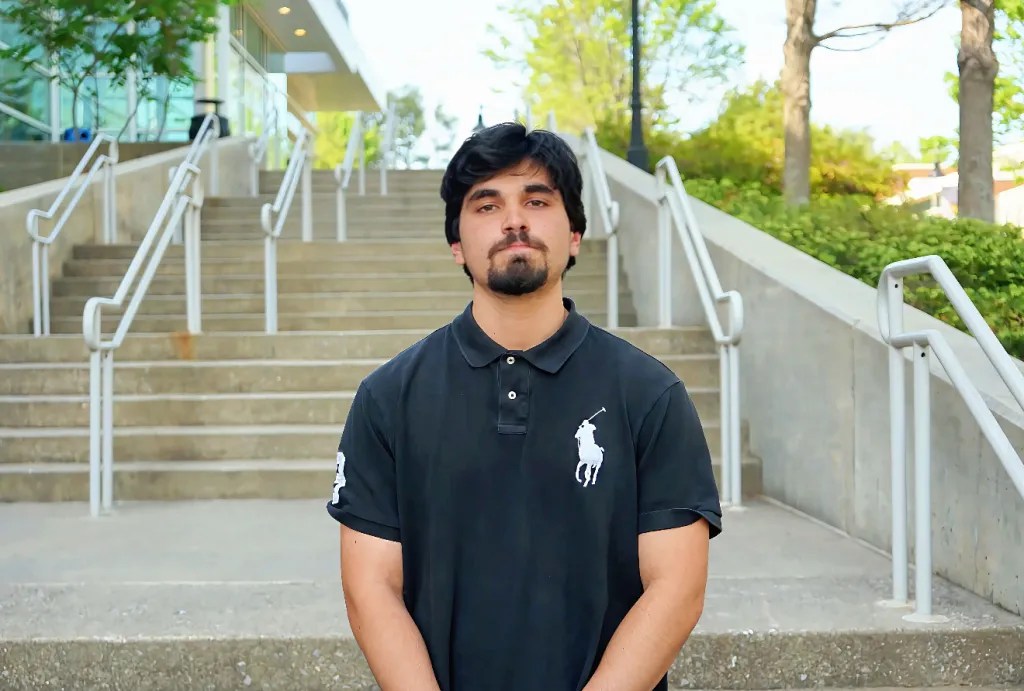 Photo by Devyn Byers. Master’s student Vijay Wulfekuhle stands outside KSU’s Engineering Technology Center on the Marietta campus.