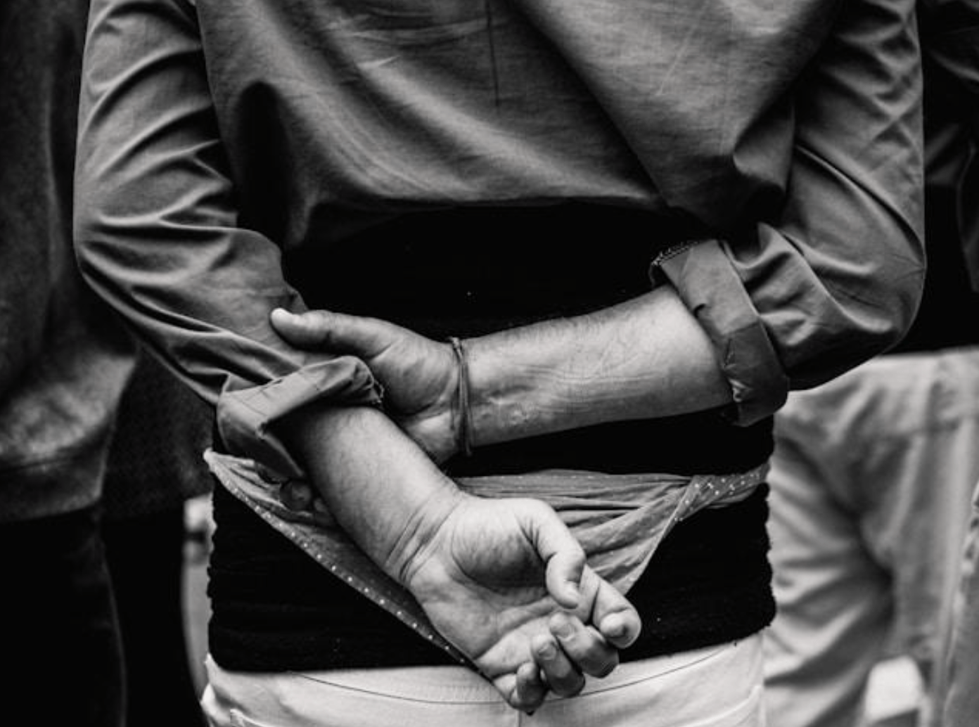 Man with hands behind back image by Nicolas Gras via Unsplash.com