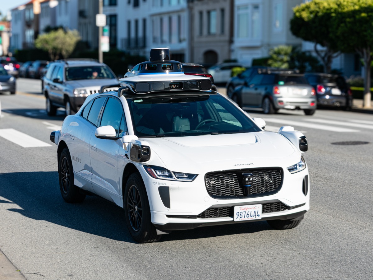 waymo driverless car white street