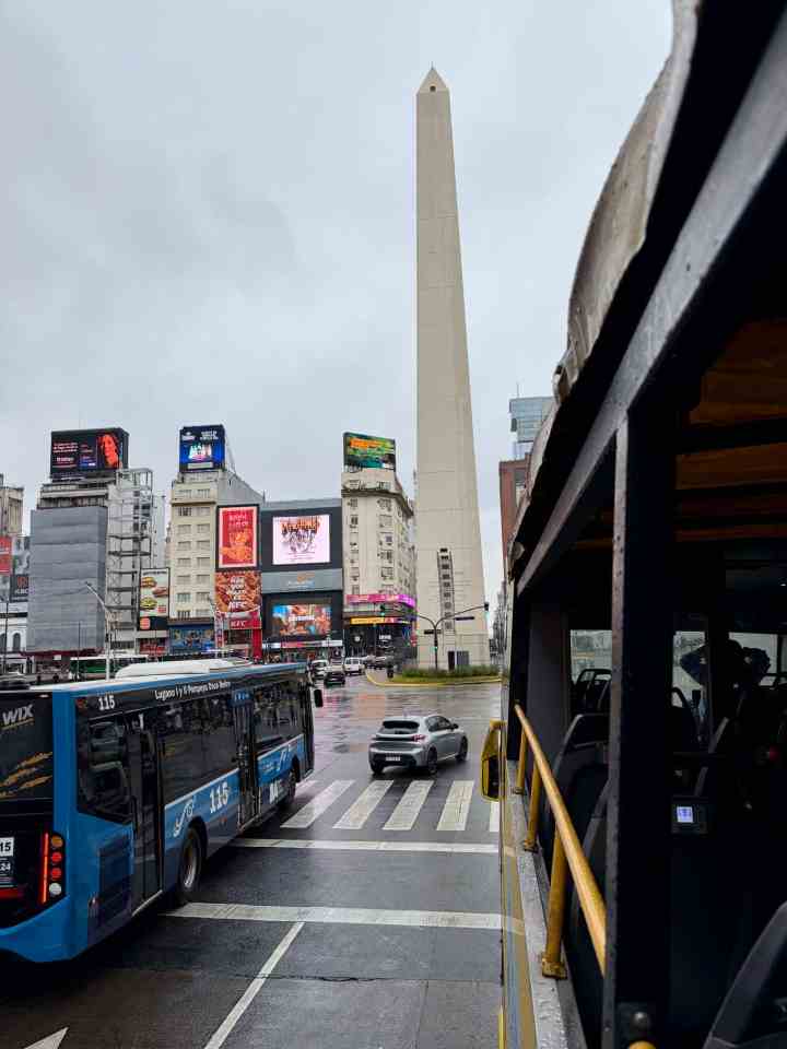 An upclose view of El Obelisco from the yellow Buenos Aires Bus