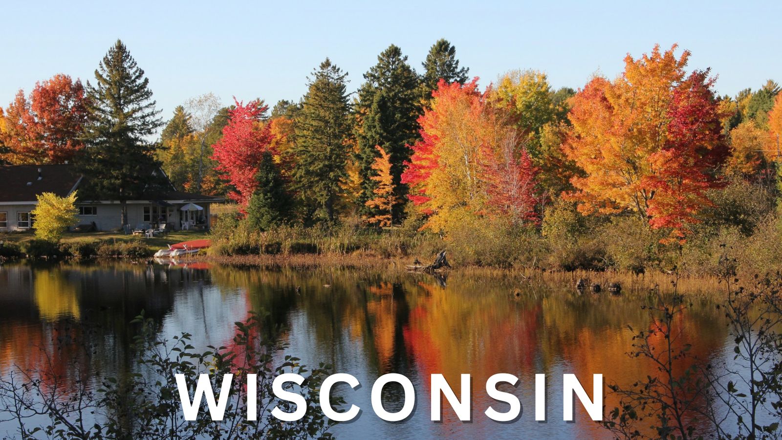 Autumn lake scene in northern Wisconsin with colorful fall trees reflected in the water