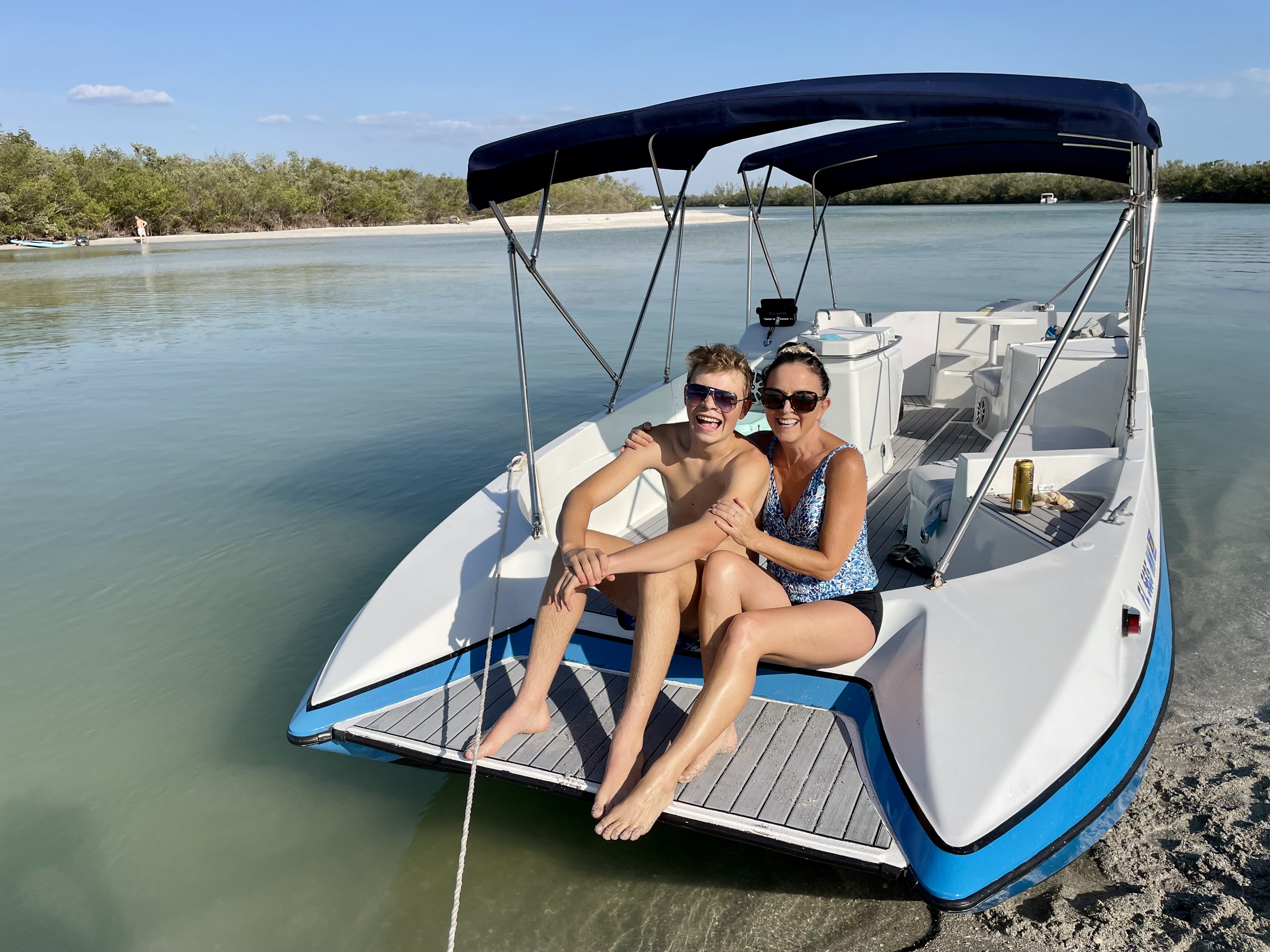 Happy mom and son smiling on the bow during a private boat tour near Sarasota and Venice Florida