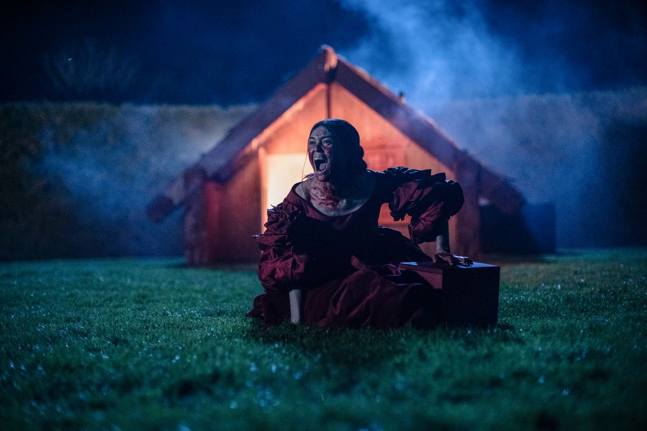 Ariana Osborne in a red dress in a Marama Still
