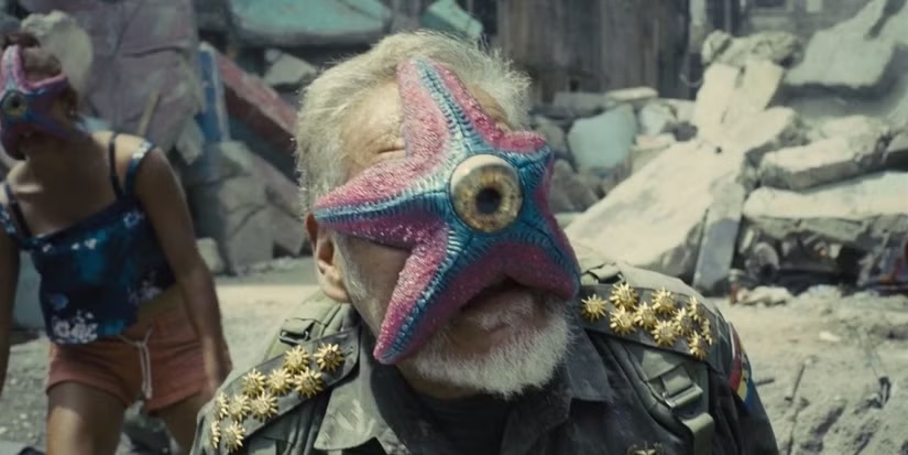 A Starro spore clamped onto a soldier's face in The Suicide Squad (2021)