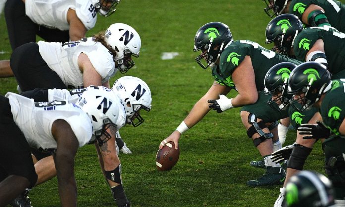 NW Mich St. Nov 28, 2020; East Lansing, Michigan, USA; Michigan State Spartans offensive line lines up against the Northwestern Wildcats defensive line during the game at Spartan Stadium. Mandatory Credit: Tim Fuller-USA TODAY Sports