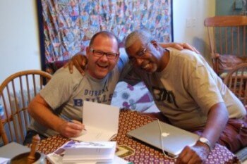 Bill Putnam signs his first book of poetry for his classmate David Anthony.