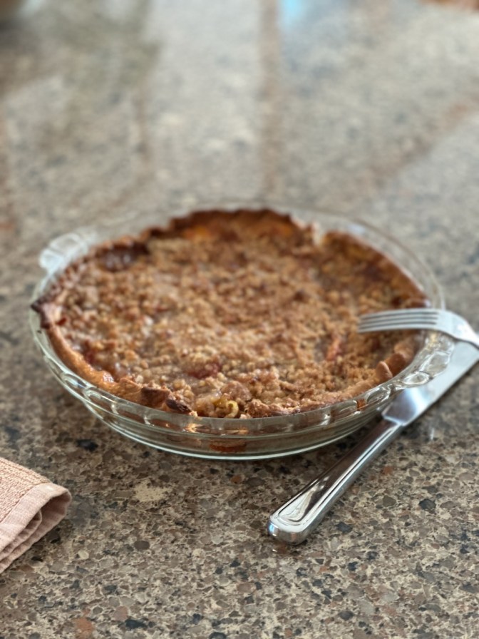Peach pie on counter.