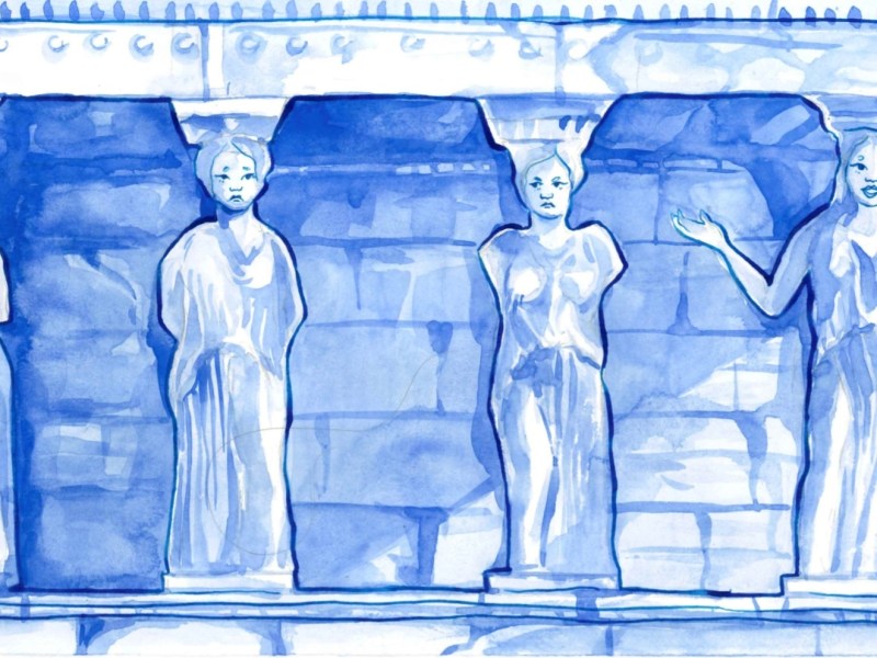 A row of statues, coloured blue, against a background of bricks on a temple.