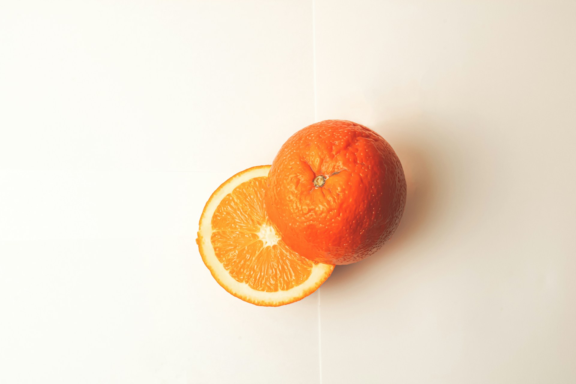 A sliced orange on a white table.