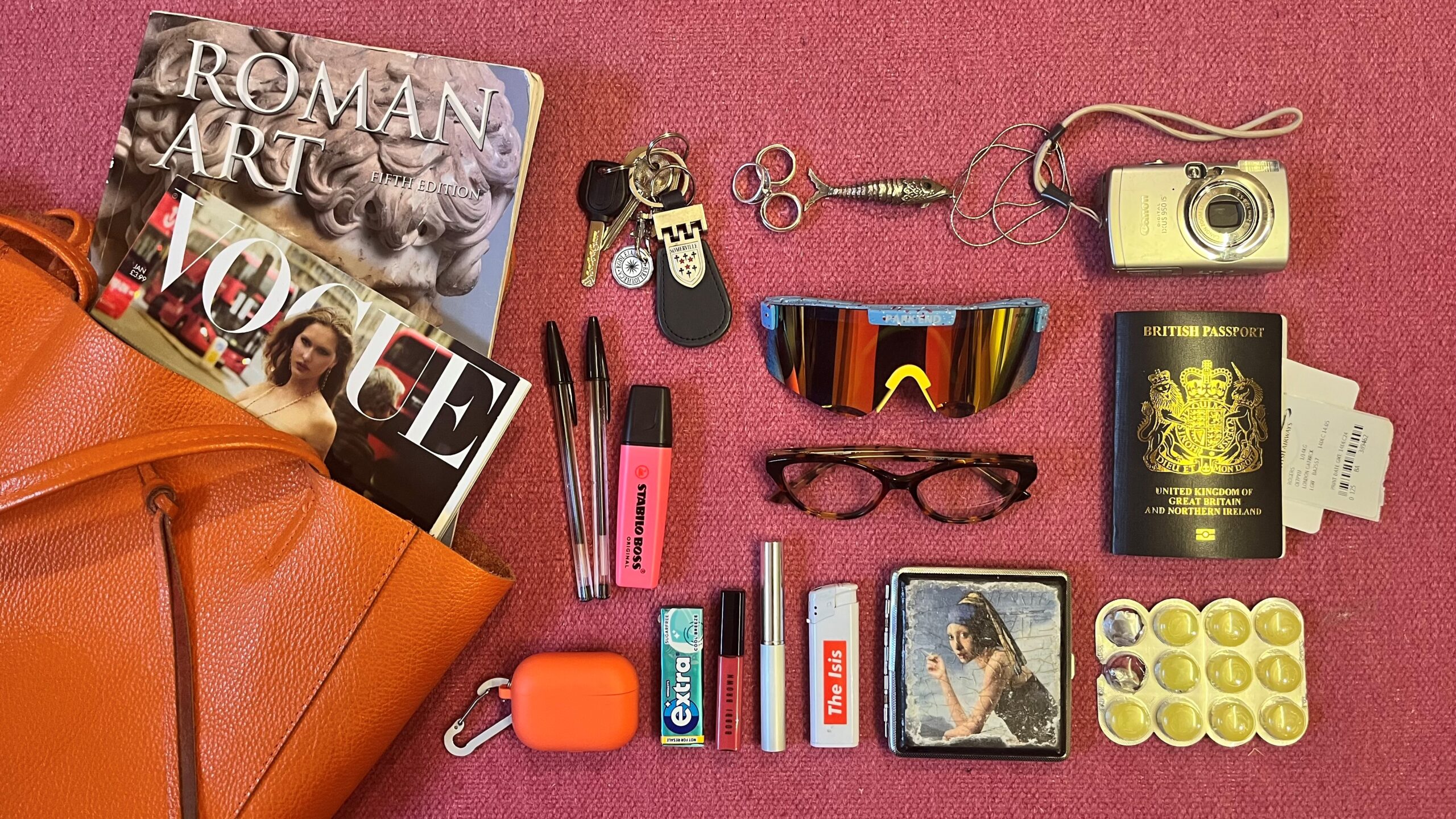 An open bag with books and everyday objects falling out.