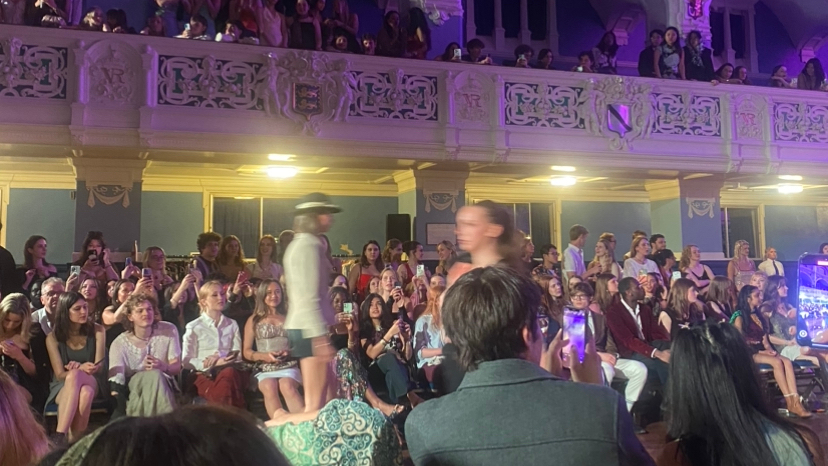 Models walking at the Oxford Fashion Gala in Oxford Town Hall, with students in the fore- and background watching