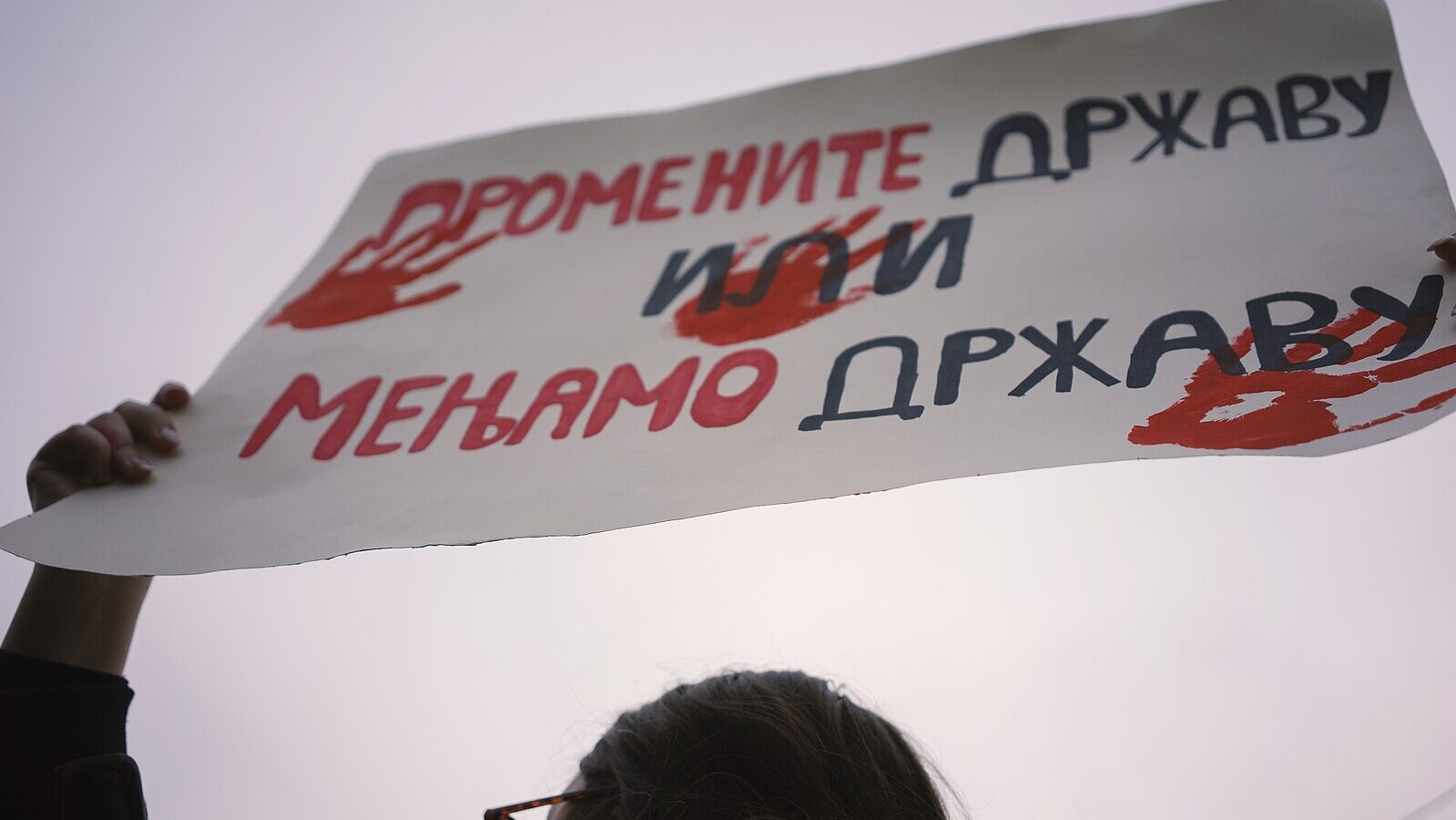 Cacak, Serbia - January 26, 2025: "Change country or we change country". Protests in Serbia regarding the fall of a concrete canopy in Novi Sad where 15 people died. Citizens demand that the authorities take responsibility and punish those responsible for that event. The protests were initiated by the students of the Belgrade Drama Faculty, after which the citizens joined in and are taking place in almost all cities of Serbia. This is a moment from the protest from the city of Cacak.
