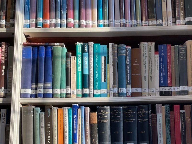 image of a white bookcase filled with colourful books