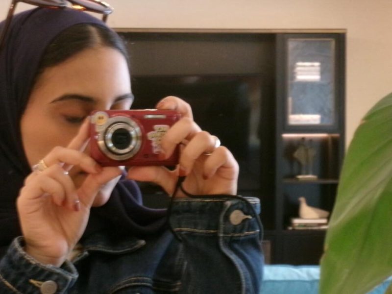 The author of the article is taking a 'mirror selfie' with a digital camera.