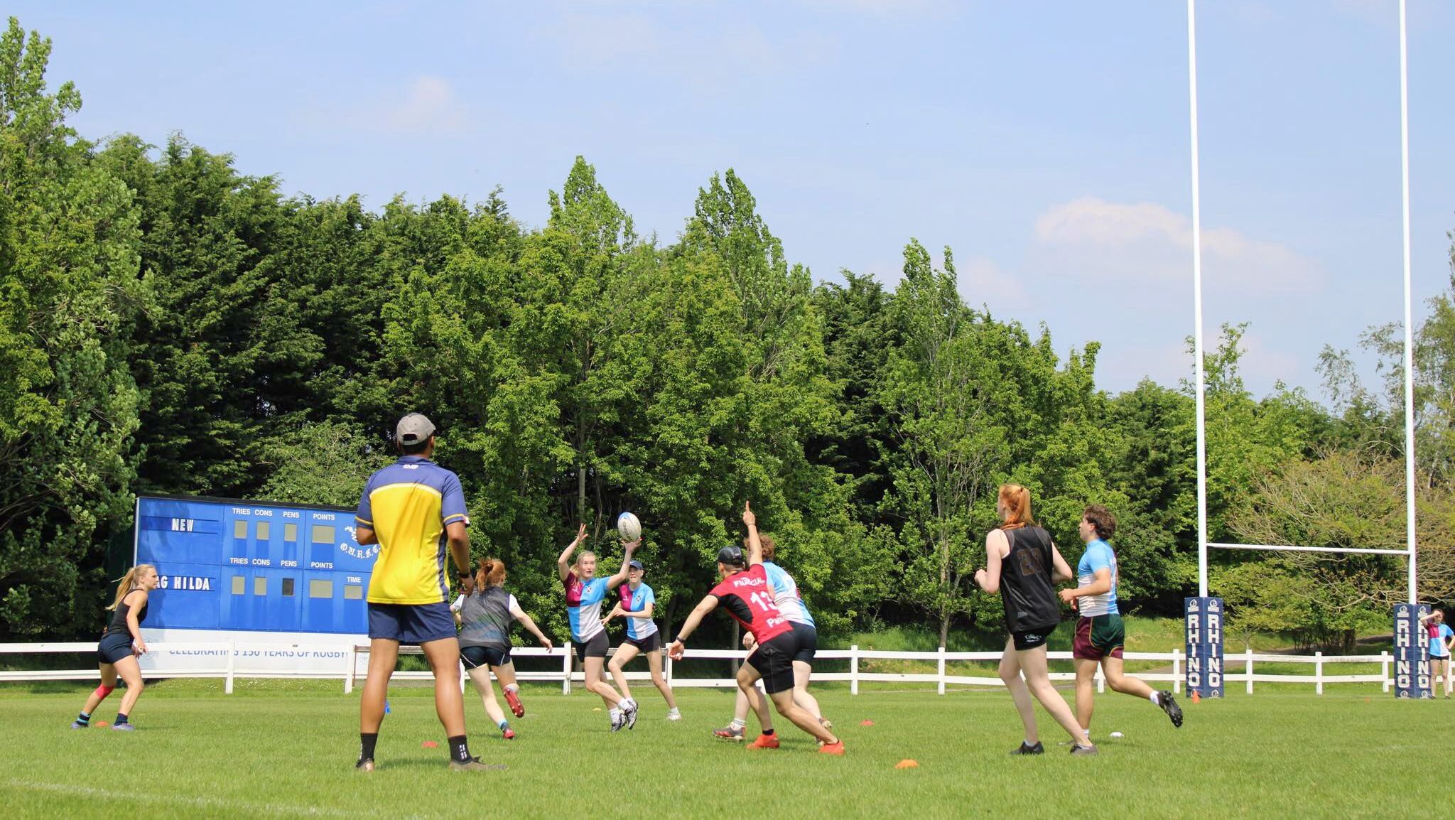 A game of touch rugby outside at a sports ground.