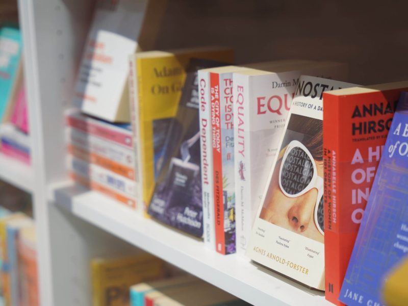 Colourful books lined up on a shelf