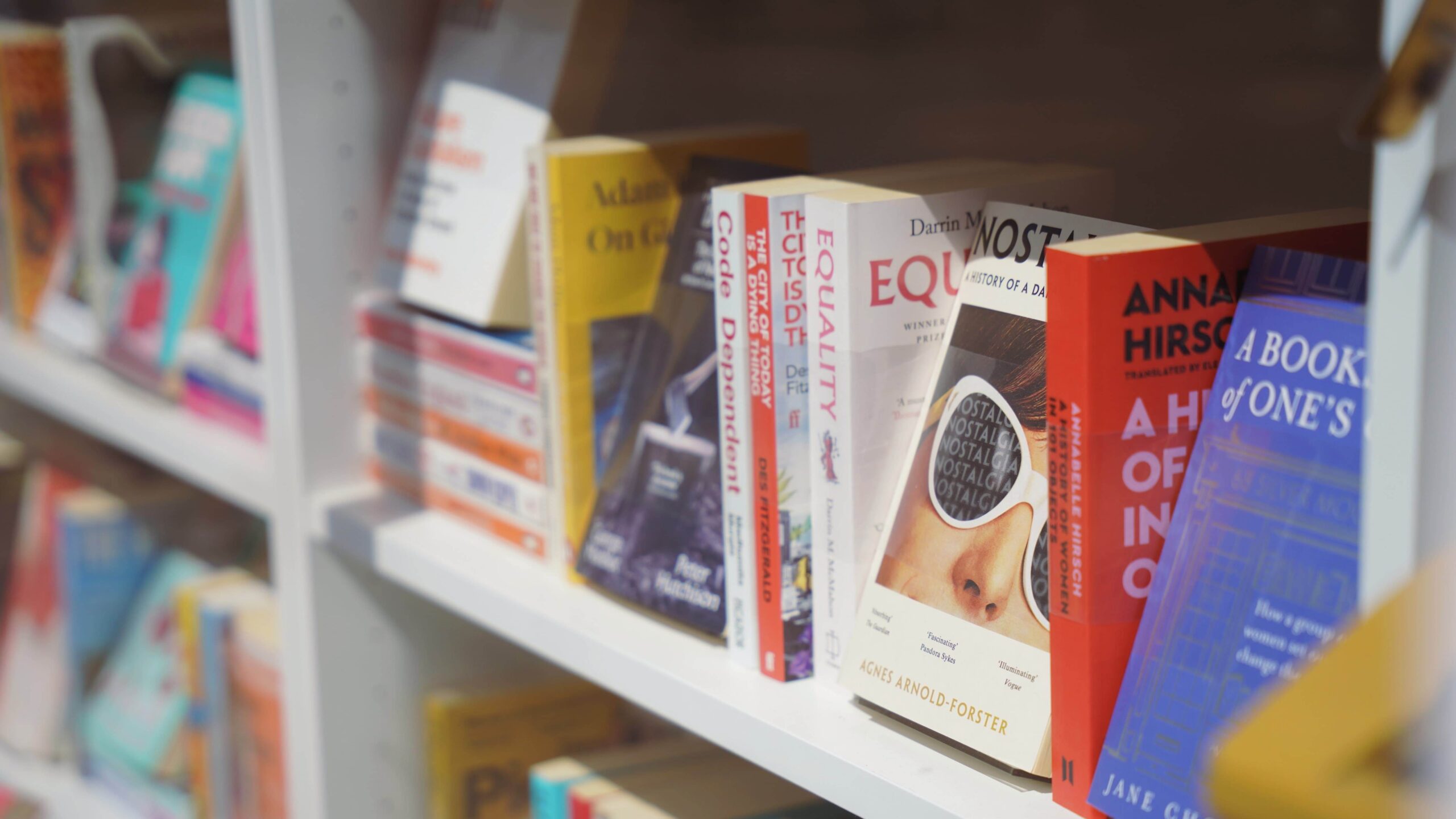 Colourful books lined up on a shelf