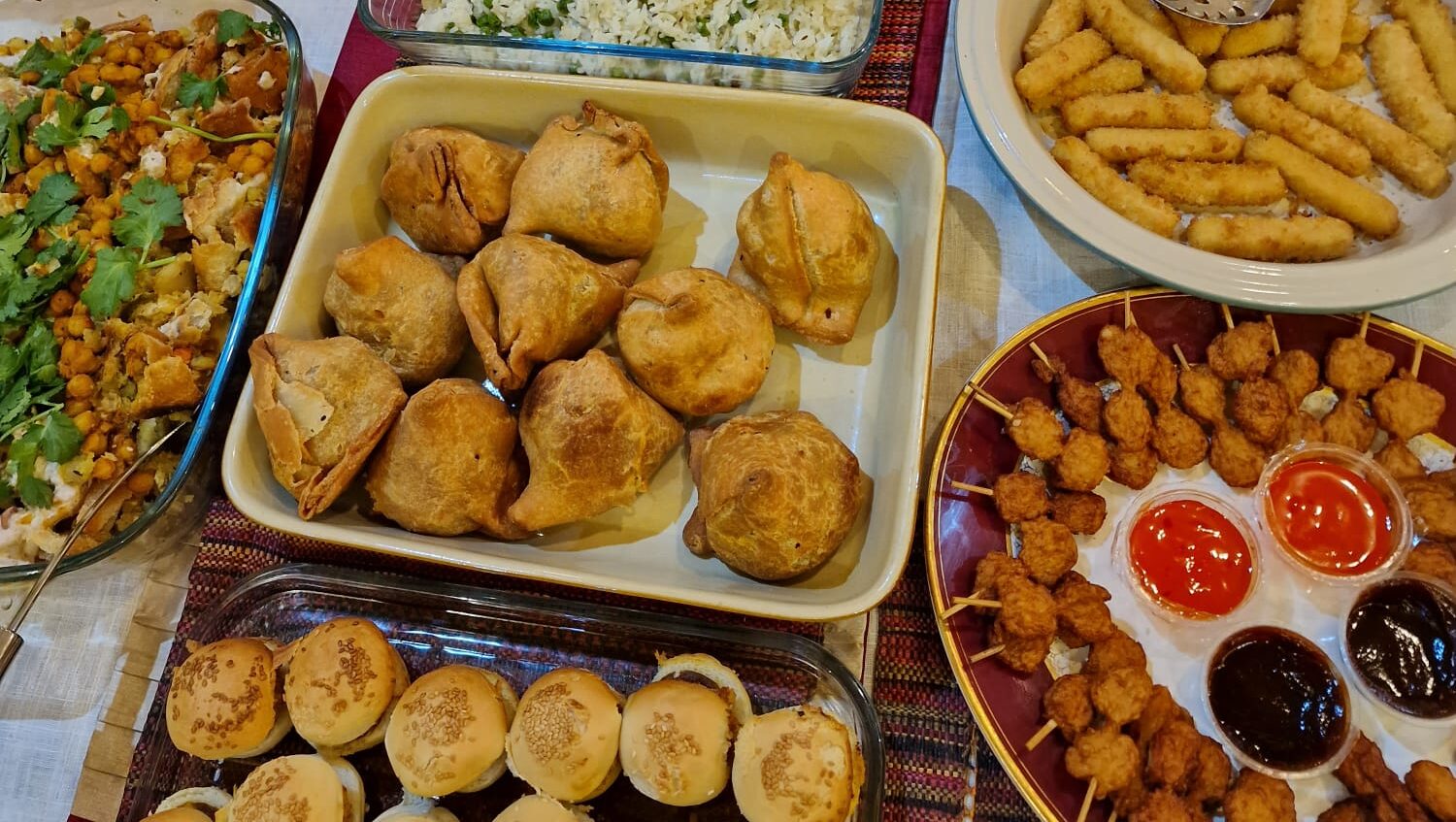 An indian home buffet including chicken curry.