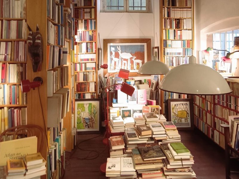 An aesthetic bookshop, filled with books and art.