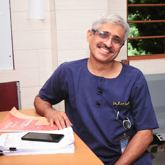 Doctor smiling while sitting at a desk