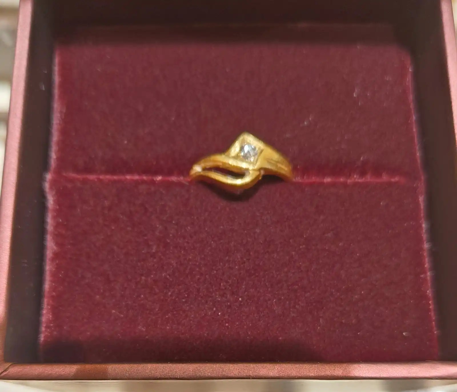 A diamond set in a gold ring
