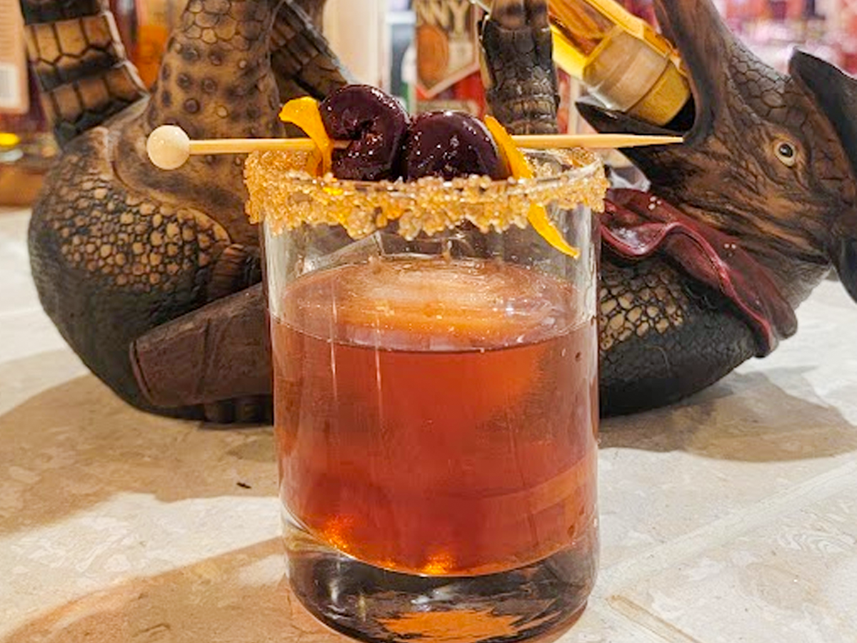 An Old Fashioned featuring homemade candied orange peels and cherries.
