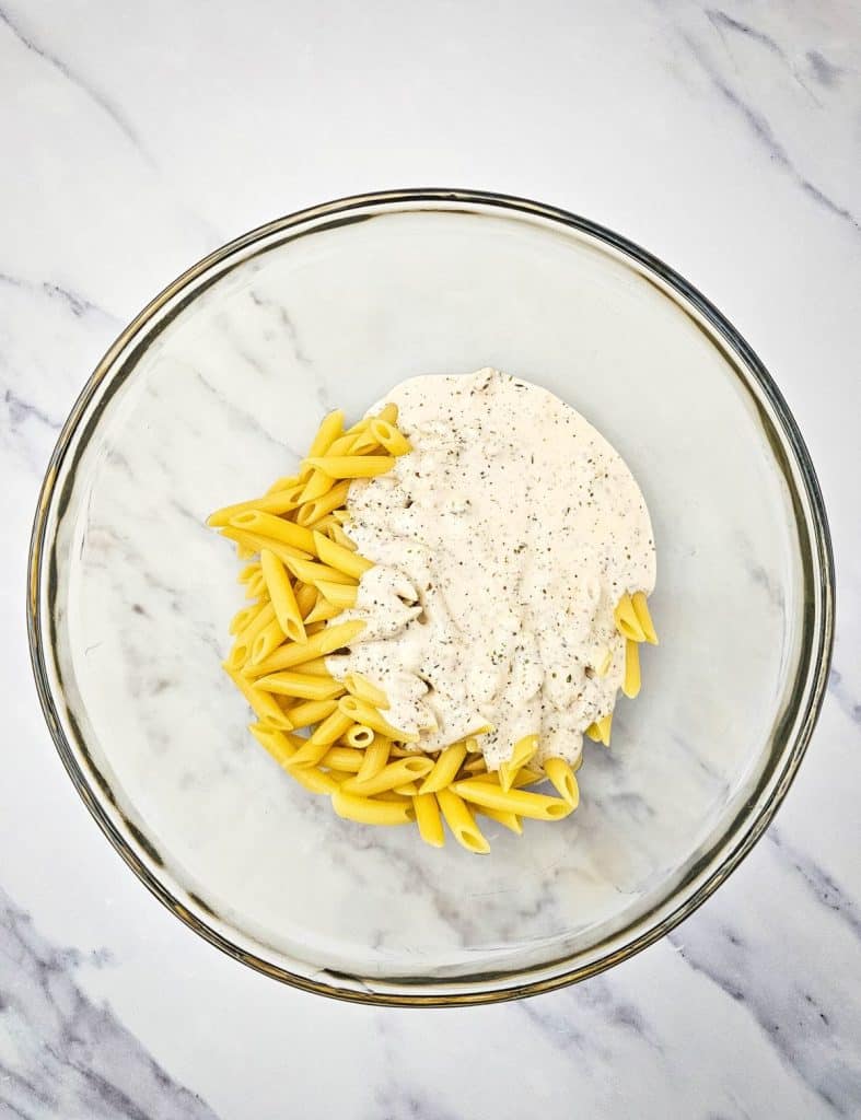 italian hoagie pasta salad ingredients in a glass mixing bowl