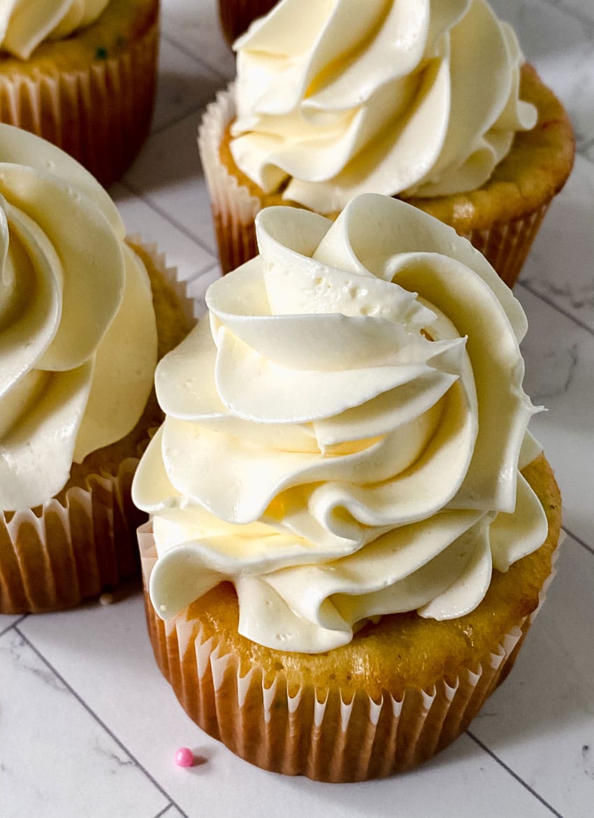 swirls of better canned frosting shown on homemade cupcakes