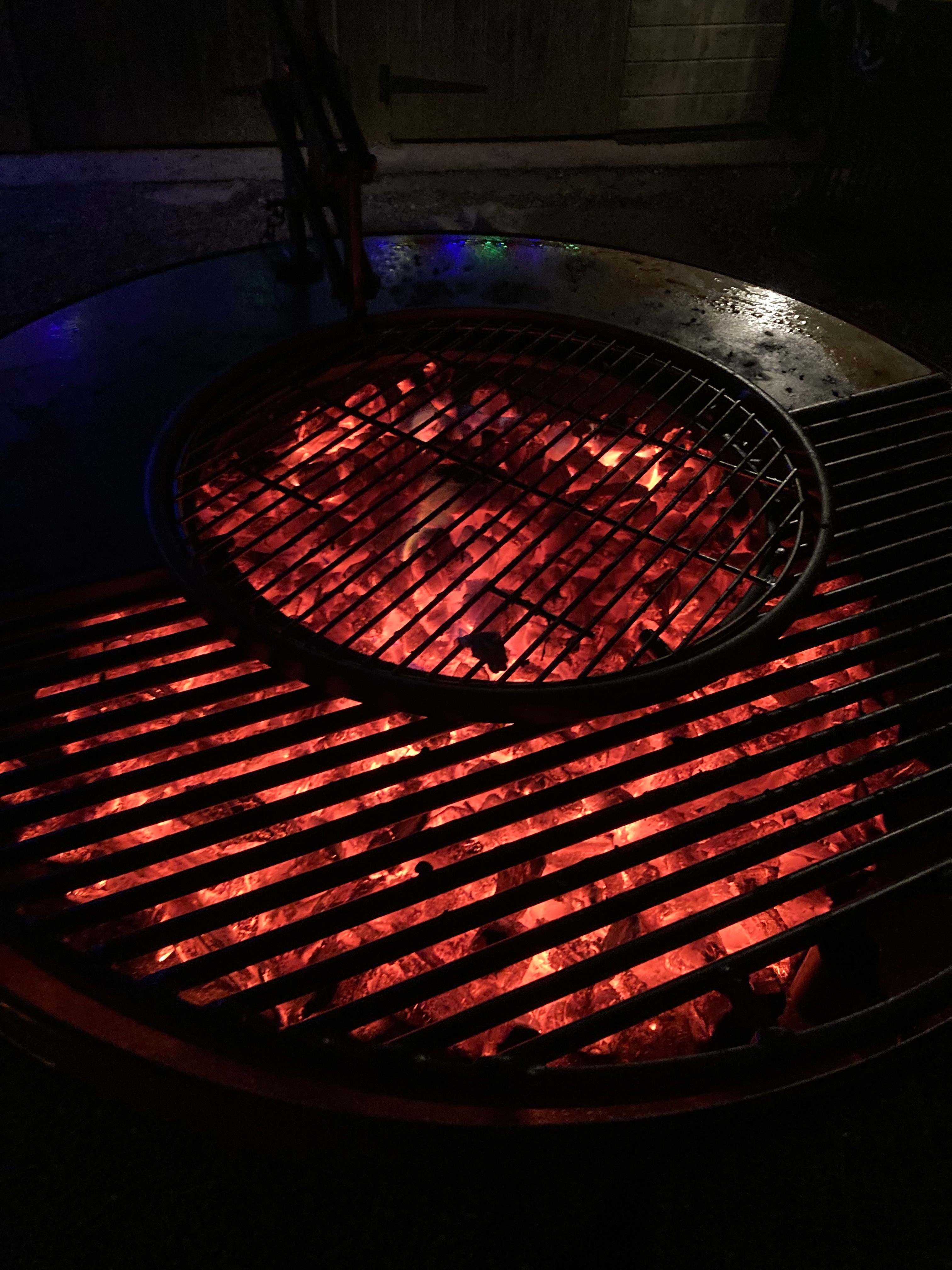 A round barbecue with glowing coals