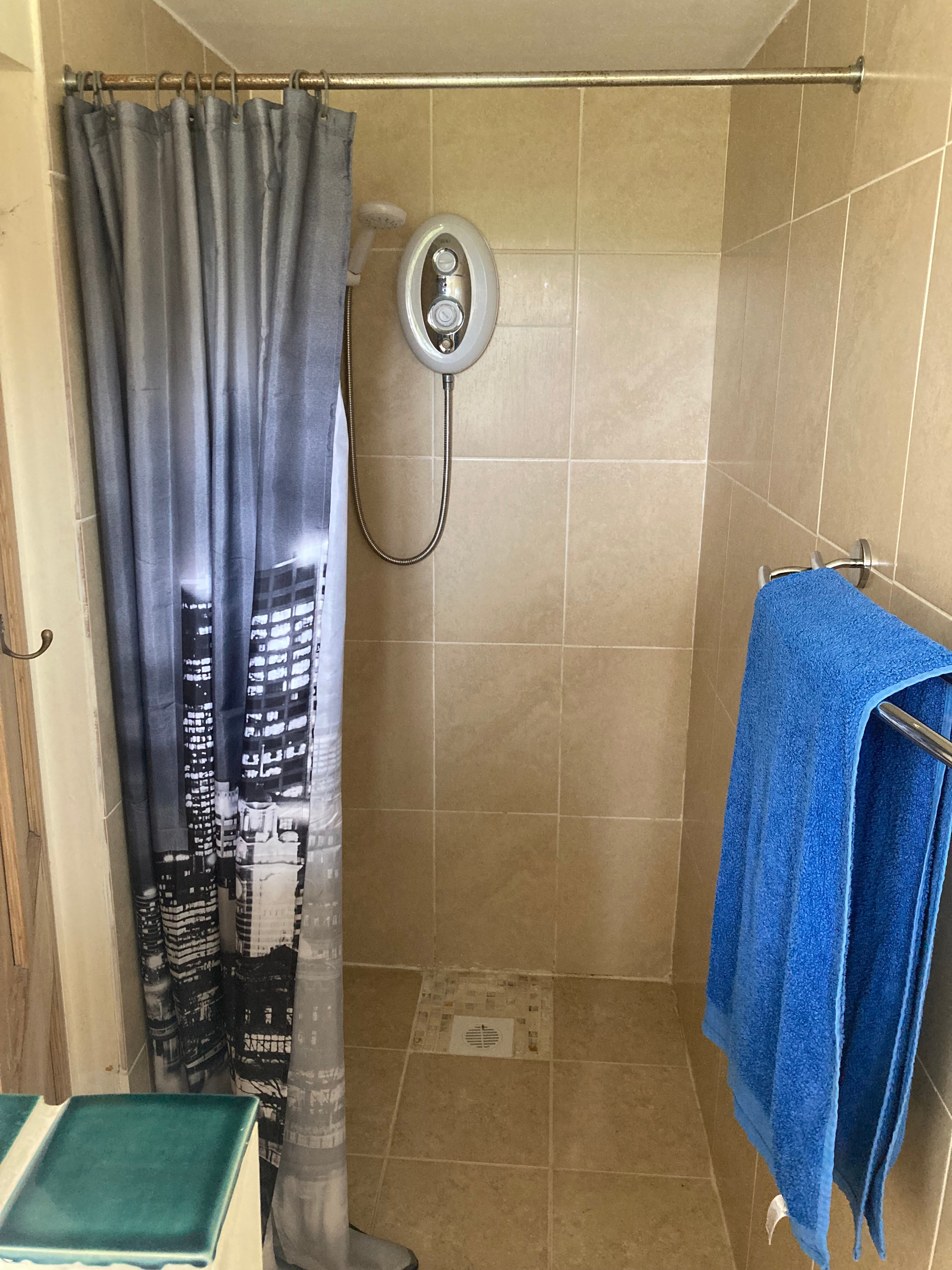 There is a walk in shower cubicle