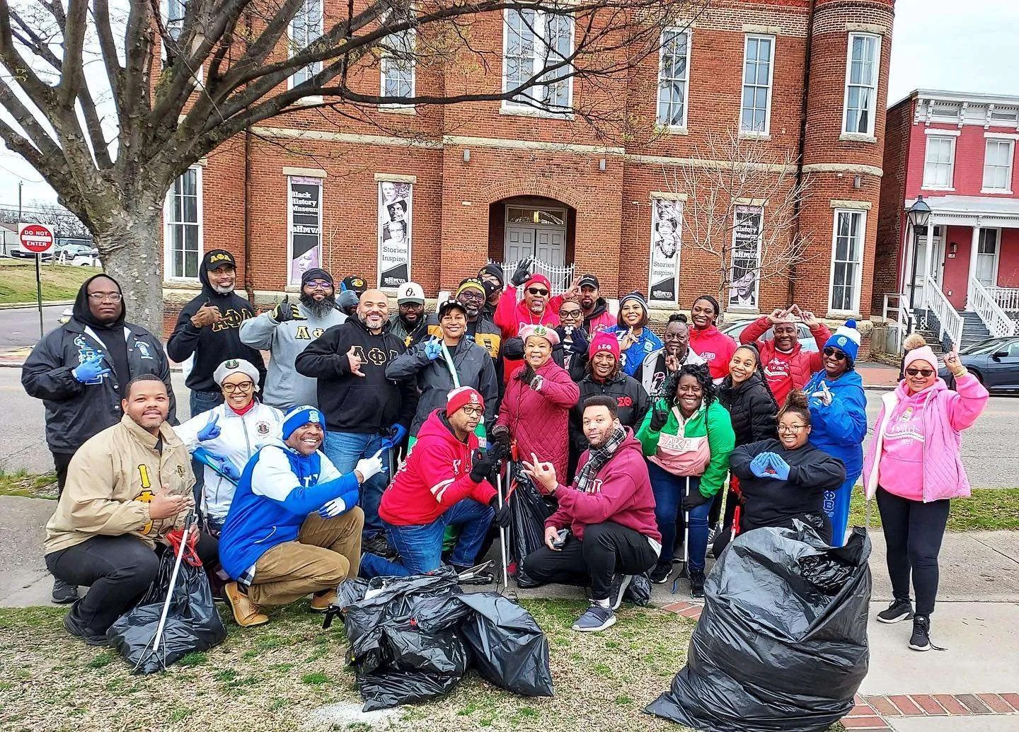 Divine Nine members posing in group photo at the conclusion of the MetroPanHellStreetCleanUp.
