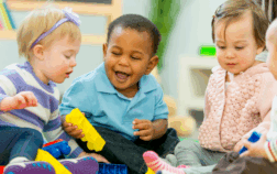 Toddlers playing together outdoors during summer — water, art, and sensory activities in action.