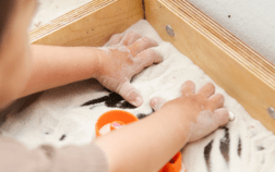 Toddler hand development at 12–18 months as a toddler uses fingers to grasp and explore during play