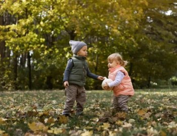 Young children practicing cooperative play and sharing during a nature-based activity