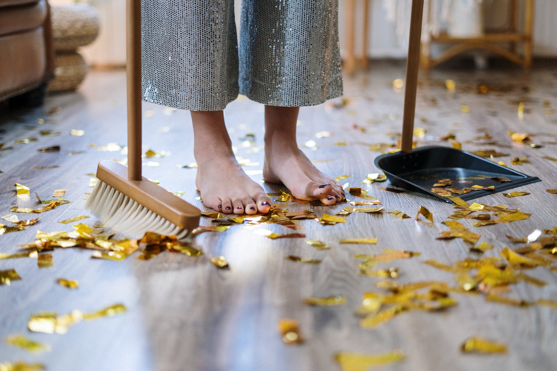 woman in gray dress standing on brown wooden floor