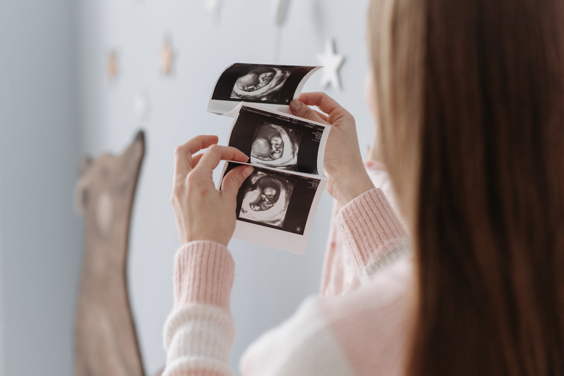 a woman holding an ultrasound image