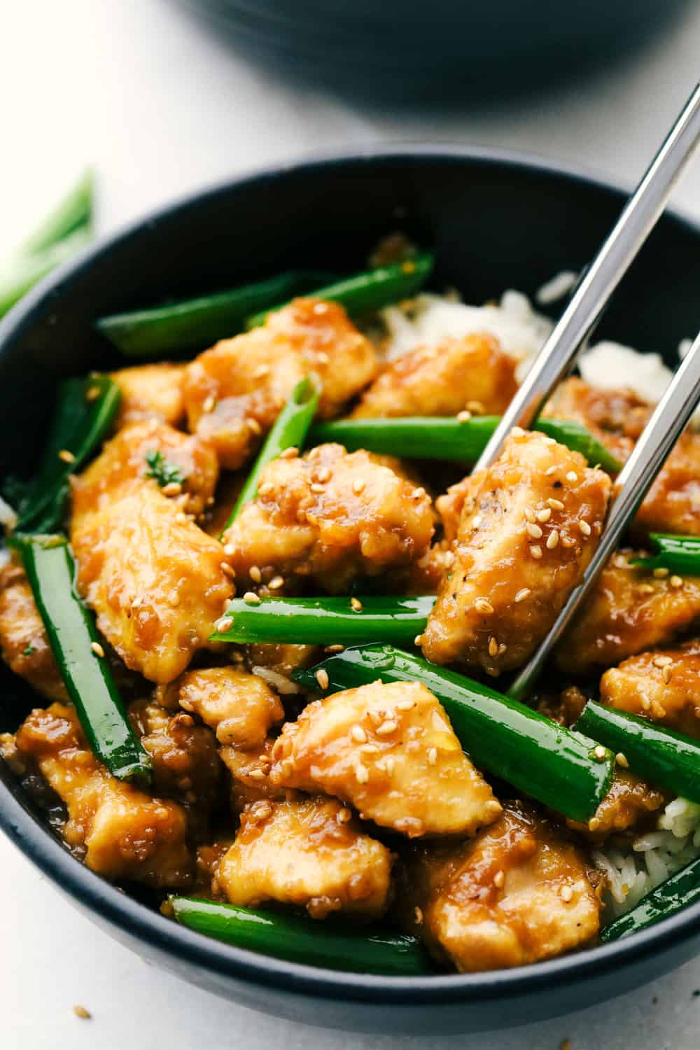 Mongolian Chicken is coated chicken tossed in a sweet savory sauce that is better than take out! This simple recipe is the beginning to tasty dinner in minutes.