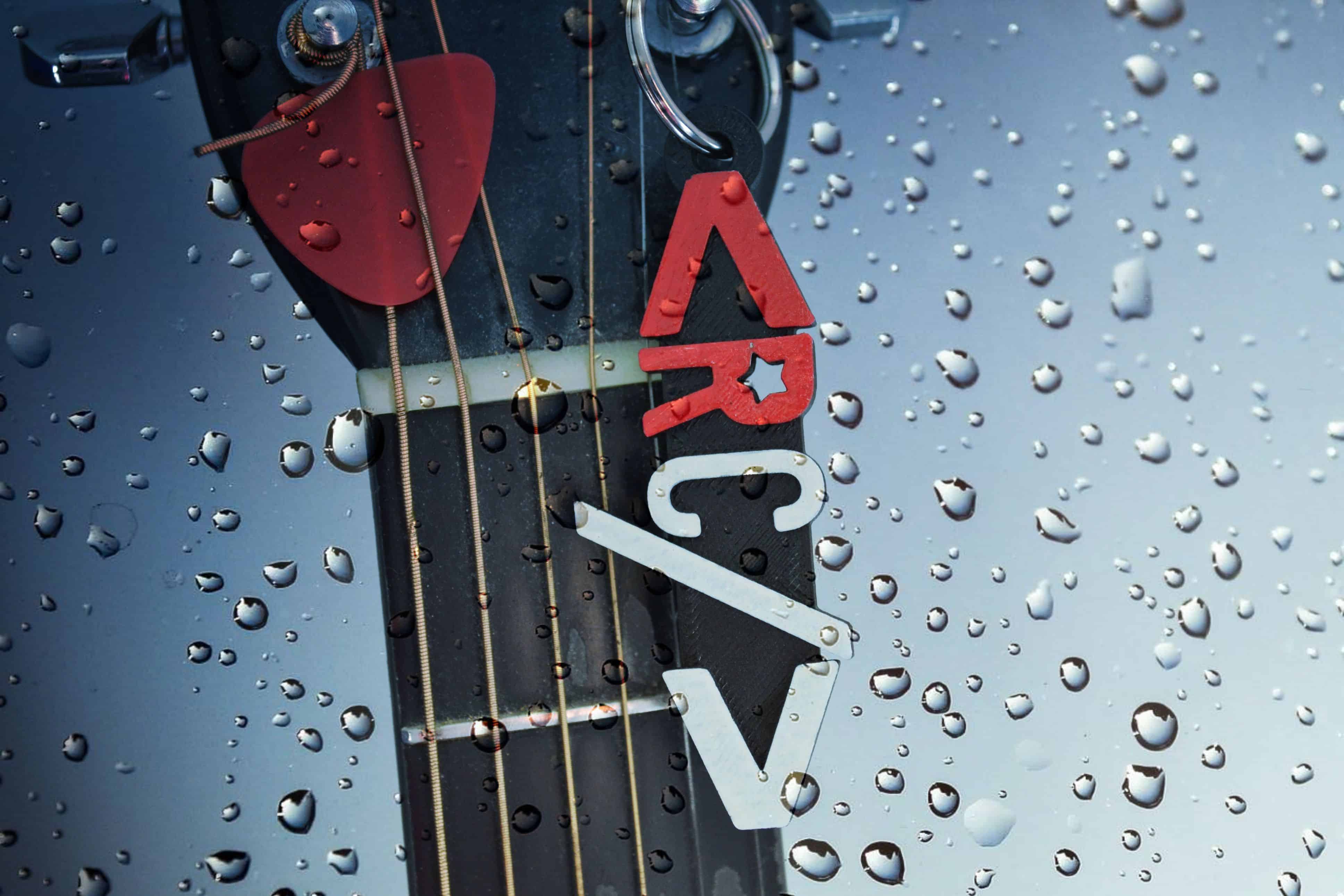 The Renegade Coder Keychain on a Guitar