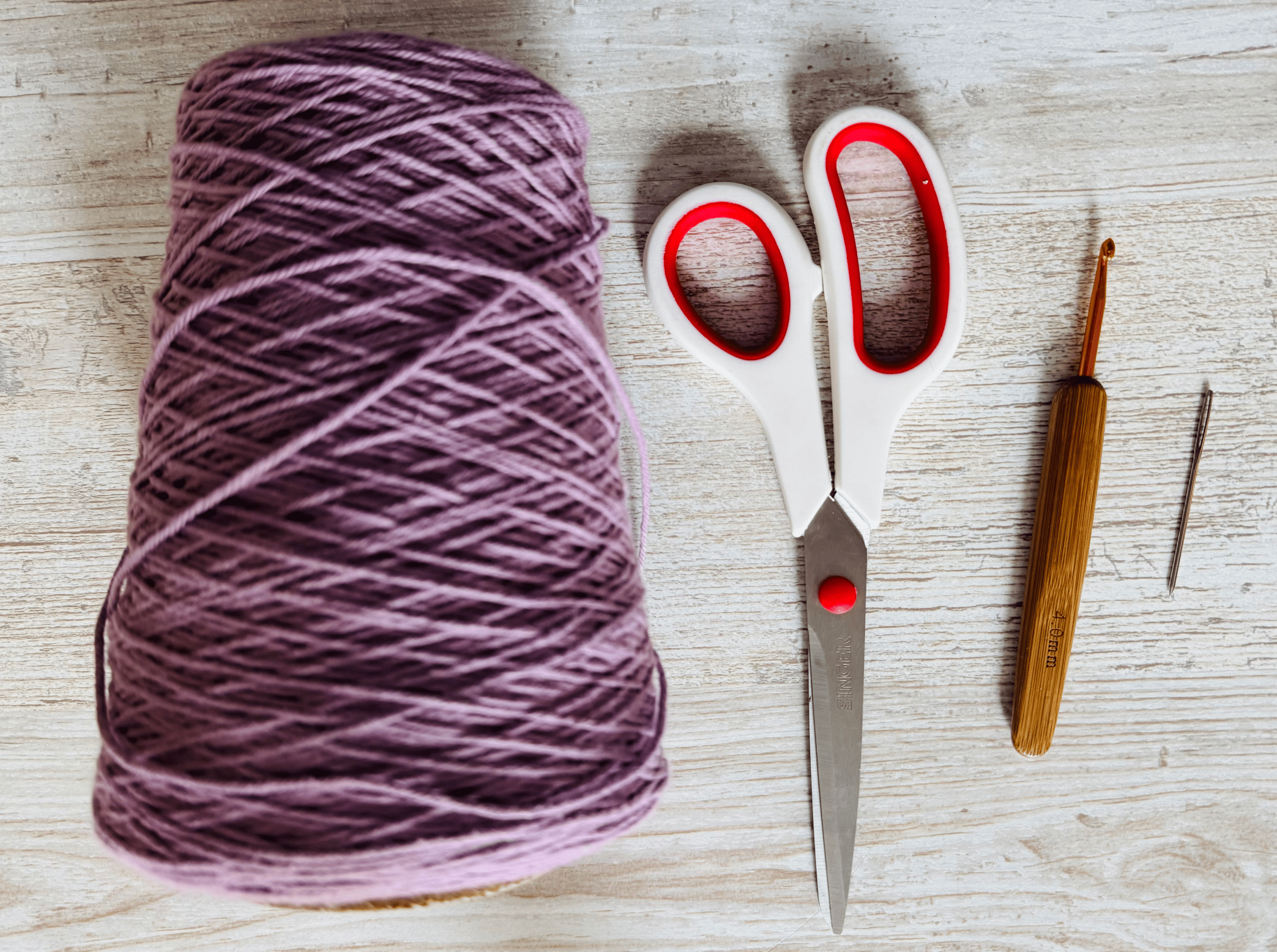 yarn, scissors, hook, needle - materials needed to crochet a dishcloth
