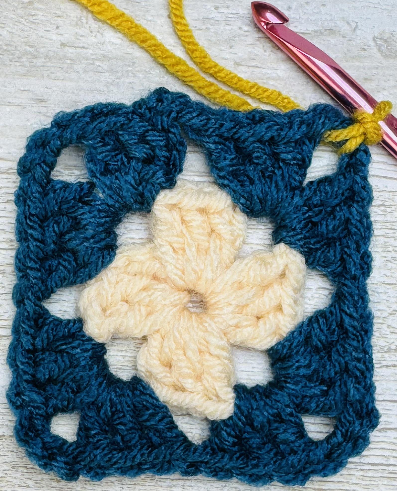 How to crochet a granny square, Round 3: Join new color with ss to any corner.