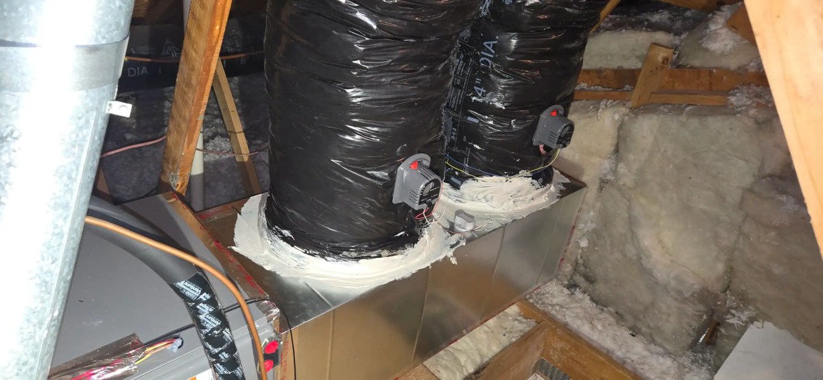 Completed residential HVAC installation with zoned ductwork and indoor evaporator coil system
