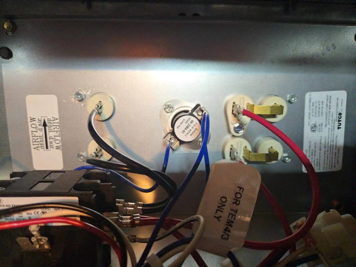 Electric heat strips inside residential HVAC air handler during heating service