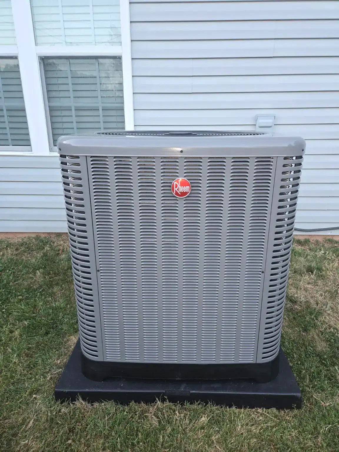 New air conditioning condenser installed outside a residential home