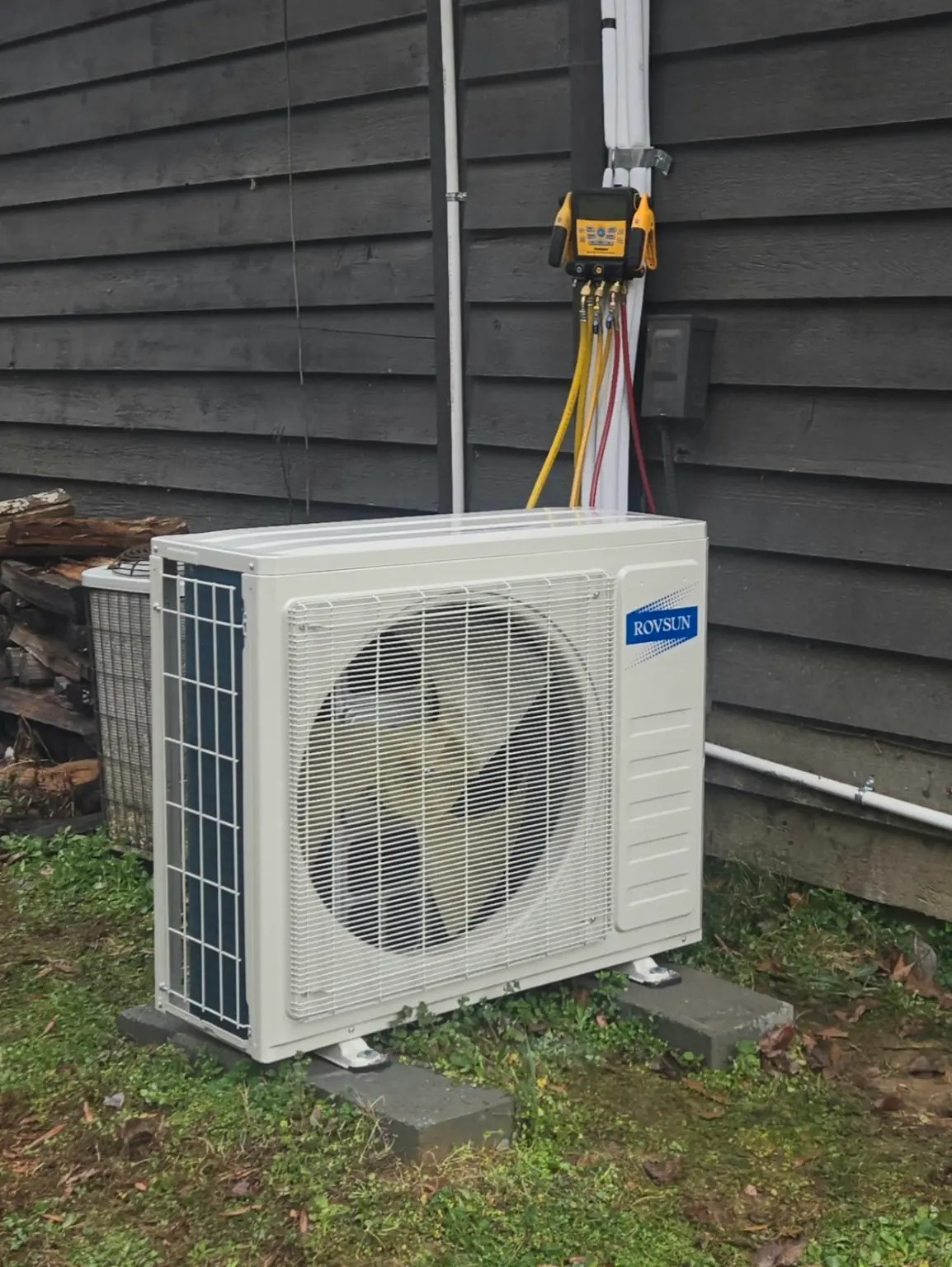 Outdoor HVAC condenser being tested with digital gauges during a real estate HVAC inspection.